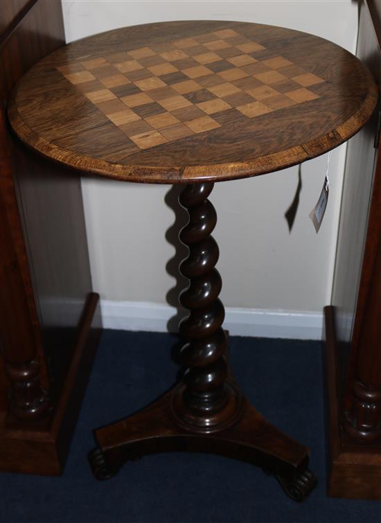 A Victorian rosewood circular table with chessboard top, 73cm high